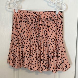 Super cute skort with fun full skirt. Peach with black spots. Size M